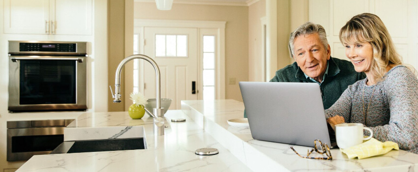 Man attentively viewing laptop at home